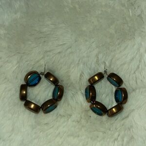 One of a kind handmade blue hoop earrings with gold toned accents.